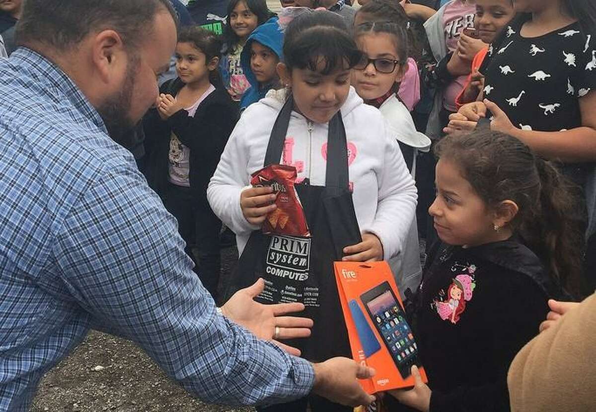 A CFISD student receives an Amazon Kindle e-reader at the iConnect Festival held in October 2018 at the Weiman Mobile Home Community.