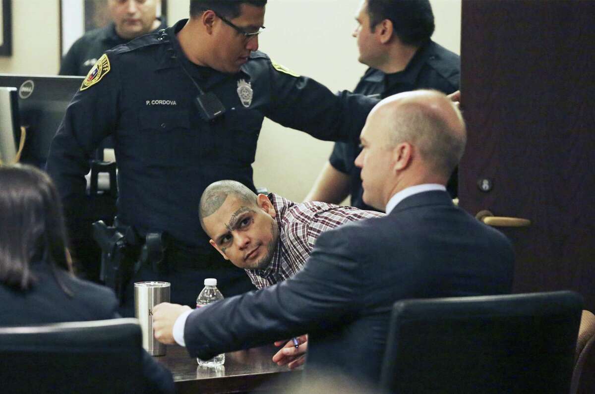 Gabriel Moreno looks toward his lawyer Albert Gutierrez during the reading of a not guilty verdict Wednesday in his retrial in the murder of Jose Luis “PeeWee” Menchaca.