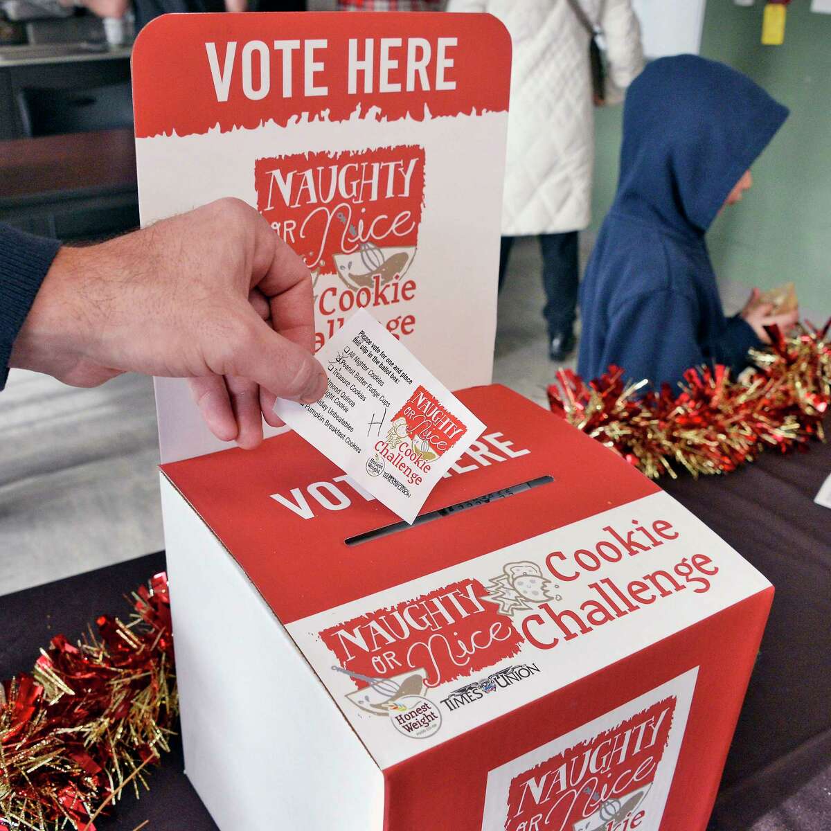 Participants cast their ballots during the Naughty or Nice Cookie Challenge at Honest Weight Food Co-op Saturday Dec. 1, 2018 in Albany, NY. (John Carl D'Annibale/Times Union)