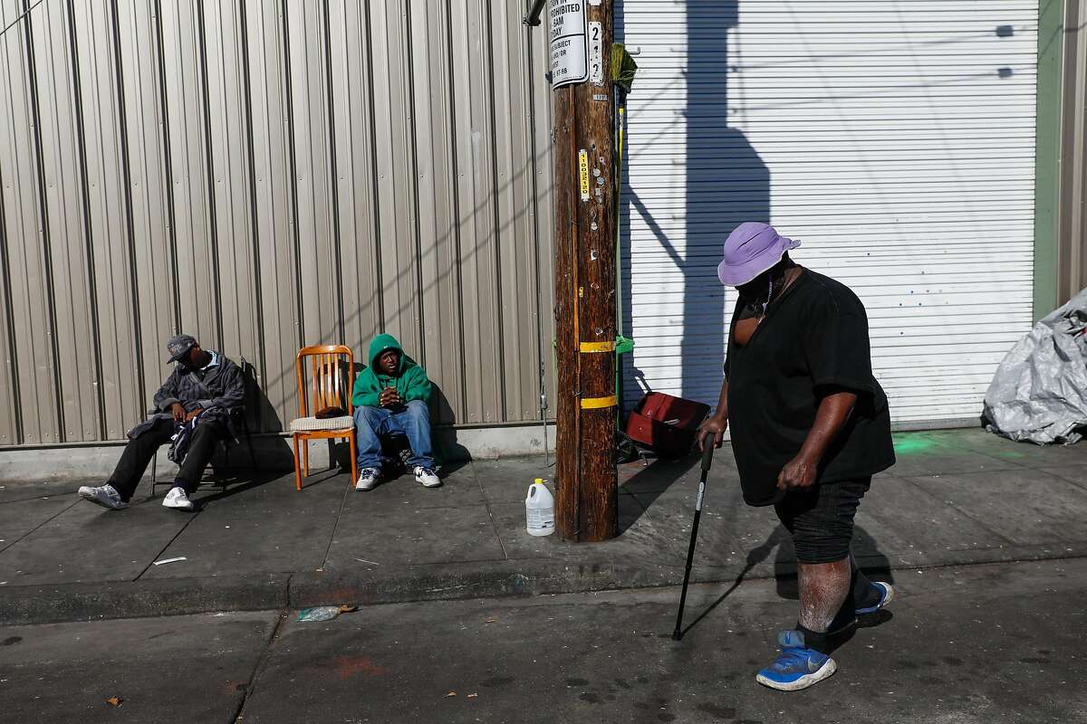 People (who wished to remain anonymous) hang out on Jennings Street outside of Mother Brown's Dining Room for the homeless in the Bayview neighborhood in San Francisco, California, on Wednesday, Oct. 31, 2018.