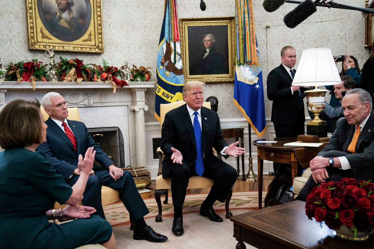 President Trump debates with House Minority Leader Nancy Pelosi, D-Calif., left, and Senate Minority Leader Chuck Schumer, D-N.Y., right, as Vice President Mike Pence listens during a meeting in the Oval Office on Tuesday.