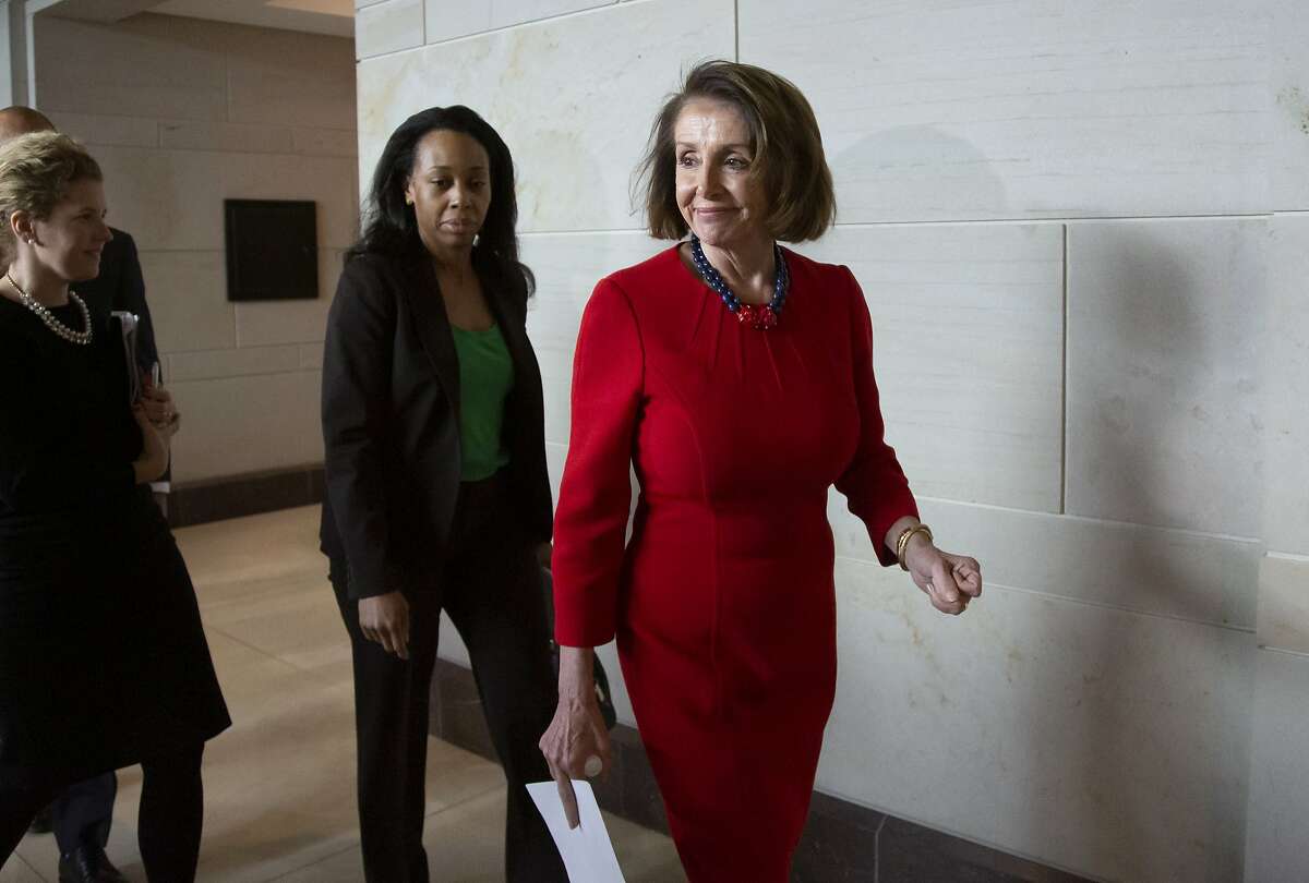 House Democratic Leader Nancy Pelosi walks past reporters at the Capitol on Dec. 12, 2018.