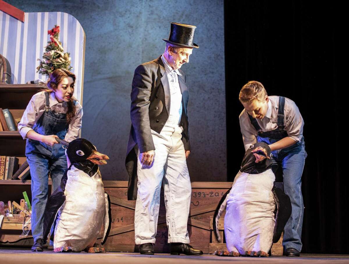 Madeline Gutierrez, from left, Jon Gentry as Mr. Popper, and Caleb Craig perform with the penguin puppets built by props master Lucian Hernandez for “Mr. Popper's Penguins” at Magik Theatre.