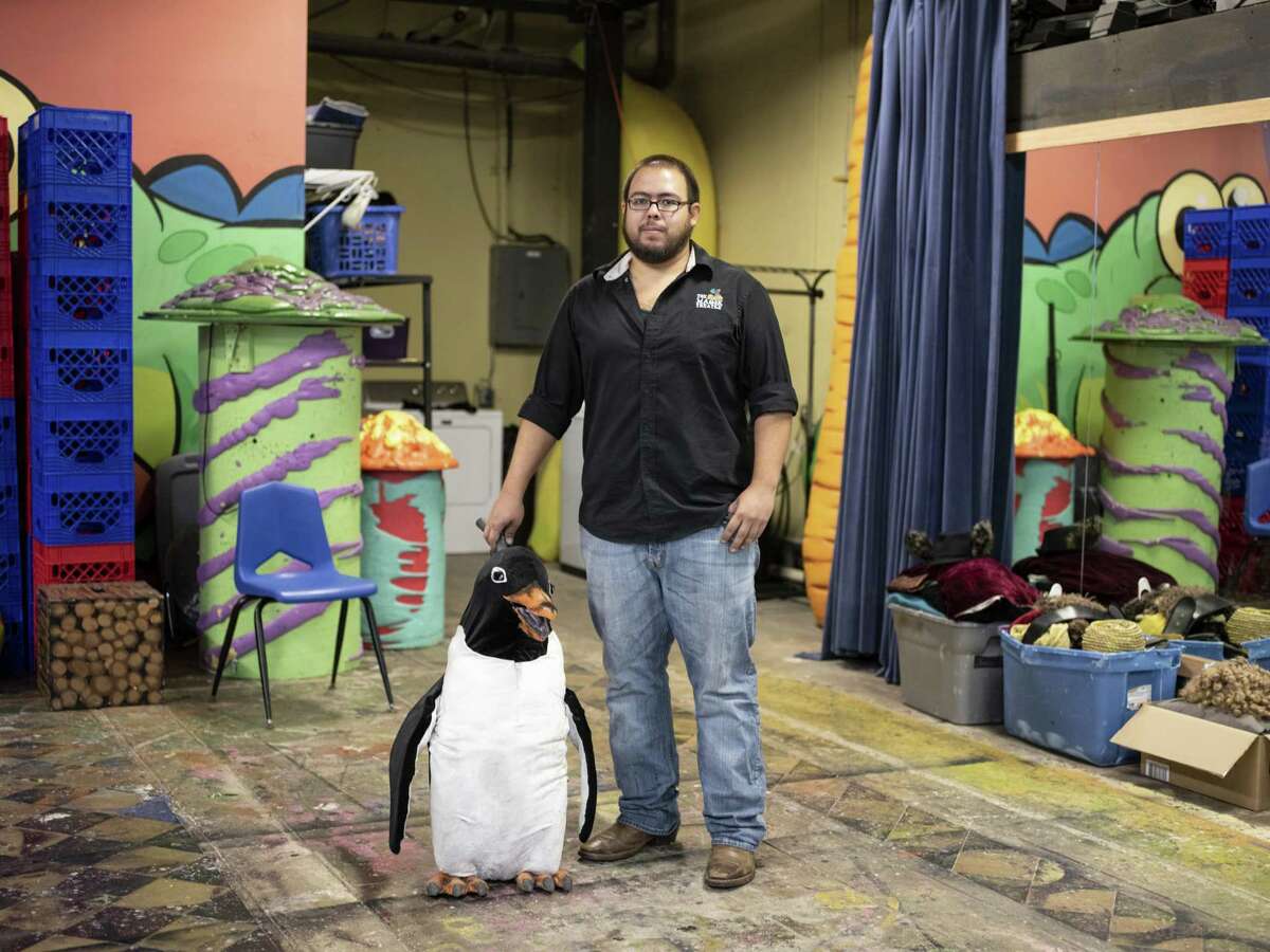 Lucian Hernandez, shows off one of the penguins he built for Magik Theatre’s staging of “Mr. Popper’s Penguins.” He built two adult-sized penguins and a seal puppet for the show, as well as constructing a rod mechanism to animate 12 stuffed baby penguins.