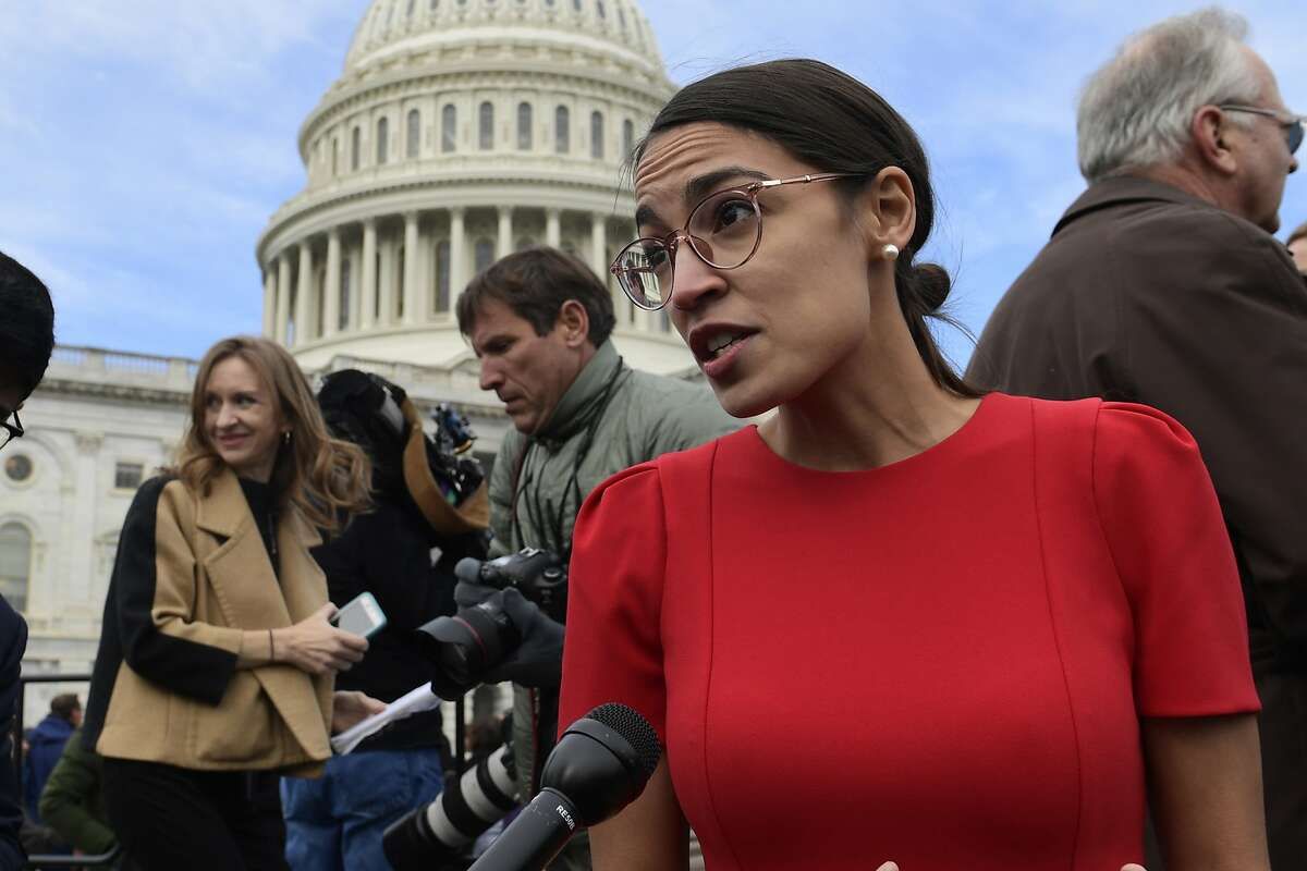In this Nov. 14, 2018 photo, Rep.-elect Alexandria Ocasio-Cortez, D-N.Y., talks with reporters following a photo opportunity on Capitol Hill in Washington. While tea party Republicans swept to power to stop things -- repeal Obamacare, roll back environmental regulations and decrease the size and scope of government -- Democrats are marching into the majority to build things back up. And after spending eight downcast years in the minority, they can’t wait to get started. (AP Photo/Susan Walsh)