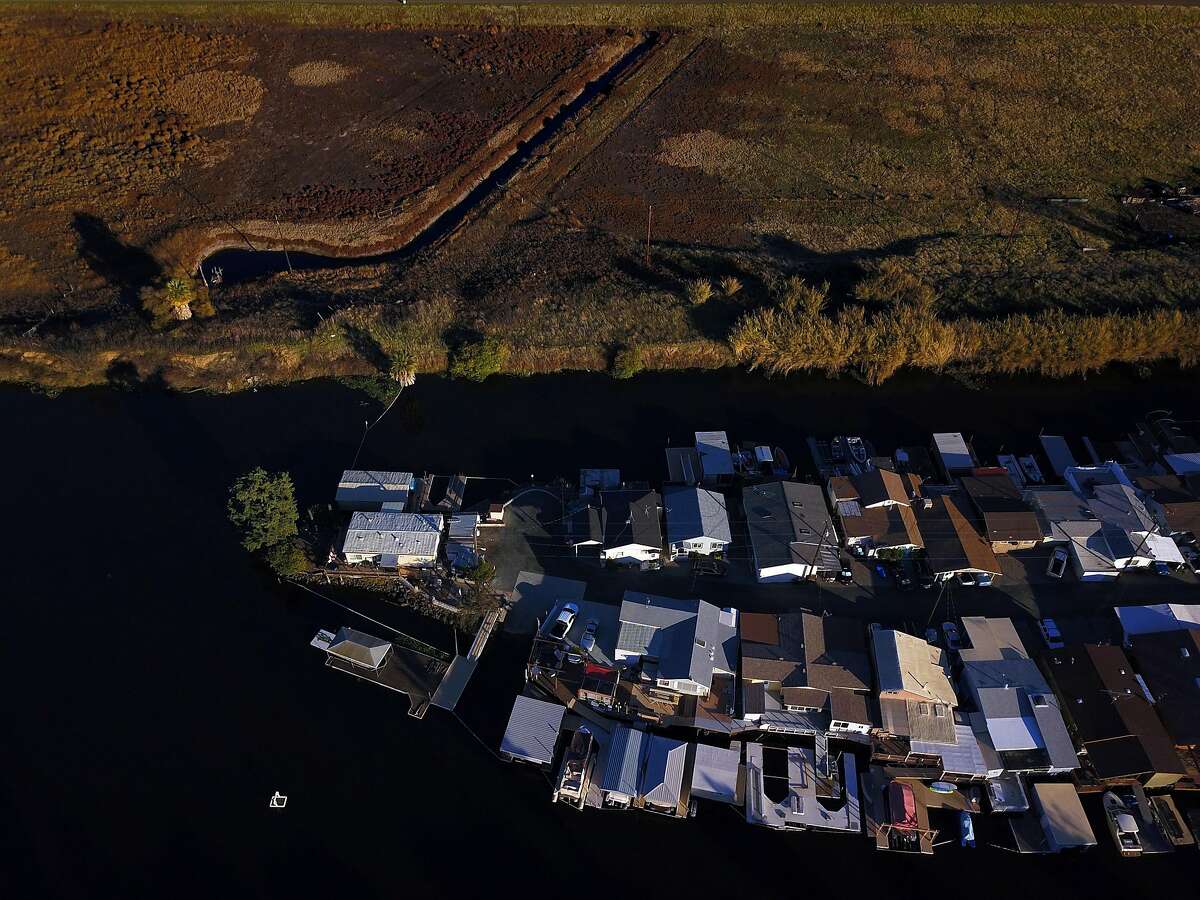 A group of homes with boat docks near Clear River Farm in the Sacramento-San Joaquin Delta outside Byron, Calif., on Tuesday, December 11, 2018. On Wednesday, the Legislature is expected to vote on a massive water bill which could decide the fate of the state's water, pitting environmentalists and sportsmen against farmers and city dwellers. No matter how the vote goes, someone will be unhappy, either the cities and suburbs, or the ranchers/farmers or the environmentalists.
