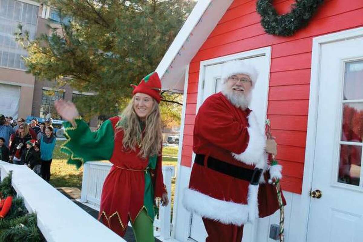 Santa Claus and his helper smile at the crowd during a previous Santa at City Park event. The event has started this year in Edwardsville and is among many activities hosted in the city during the holiday season.