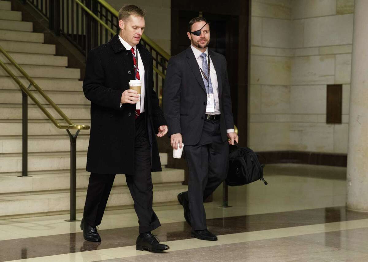 Rep.-elect, Dan Crenshaw, R-Texas., right arrives for member-elect briefings on Capitol Hill in Washington, Thursday, Nov. 15, 2018. (AP Photo/Carolyn Kaster)
