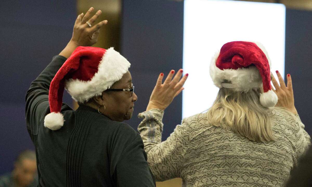 People show support to support agenda speakers who voice against Houston Independent School District potentially seeking outside partners to run several long-struggling schools during a HISD meeting on Thursday, Dec. 13, 2018, in Houston.