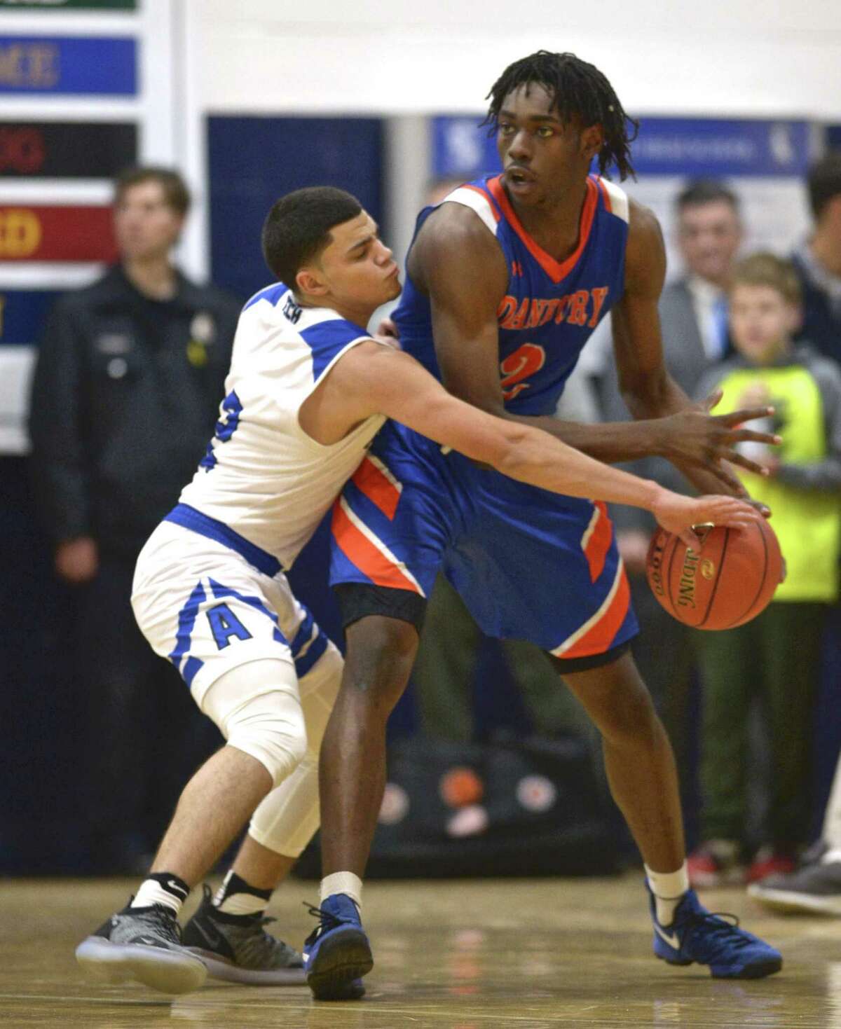Tech's Marcos Gonzalez (2) knocks away the ball from Danbury's Denali Burton (2) as Abbott Tech played Danbury High School in the opening game of The News Times Tip Off Classic basketball tournament, Thursday night, December 13, 2018, at Immaculate High School, in Danbury, Conn.