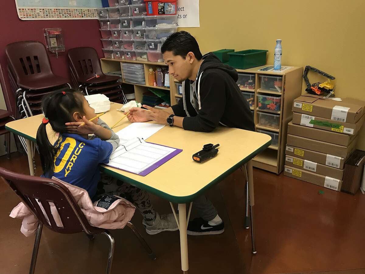 Teacher Omega Pascubello helps Kylie Chen with her math homework at an after school program at the Maureen and Craig Sullivan Youth Center run by Catholic Charities of San Francisco.