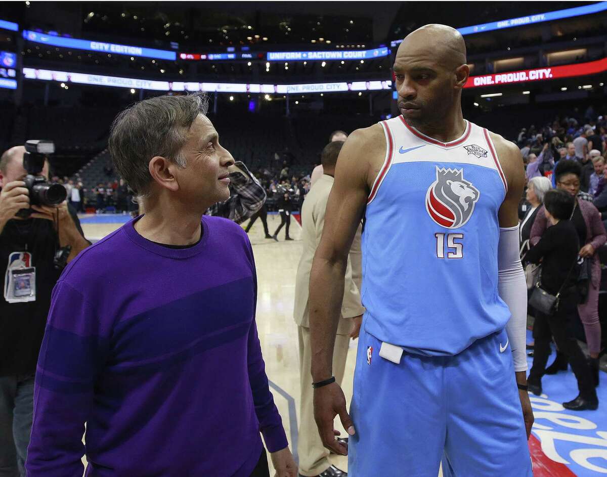 Sacramento Kings owner and chairman Vivek Ranadive talks with Kings forward Vince Carter after the Kings defeated the Atlanta Hawks 105-90 in an NBA basketball game Thursday, March 22, 2018, in Sacramento, Calif. After the game Ranadive, surrounded by players, coaches and management, addressed the fans to express their "deepest sympathies" to the family of Stephon Clark, an unarmed man who was shot and killed Sunday by Sacramento police. (AP Photo/Rich Pedroncelli)