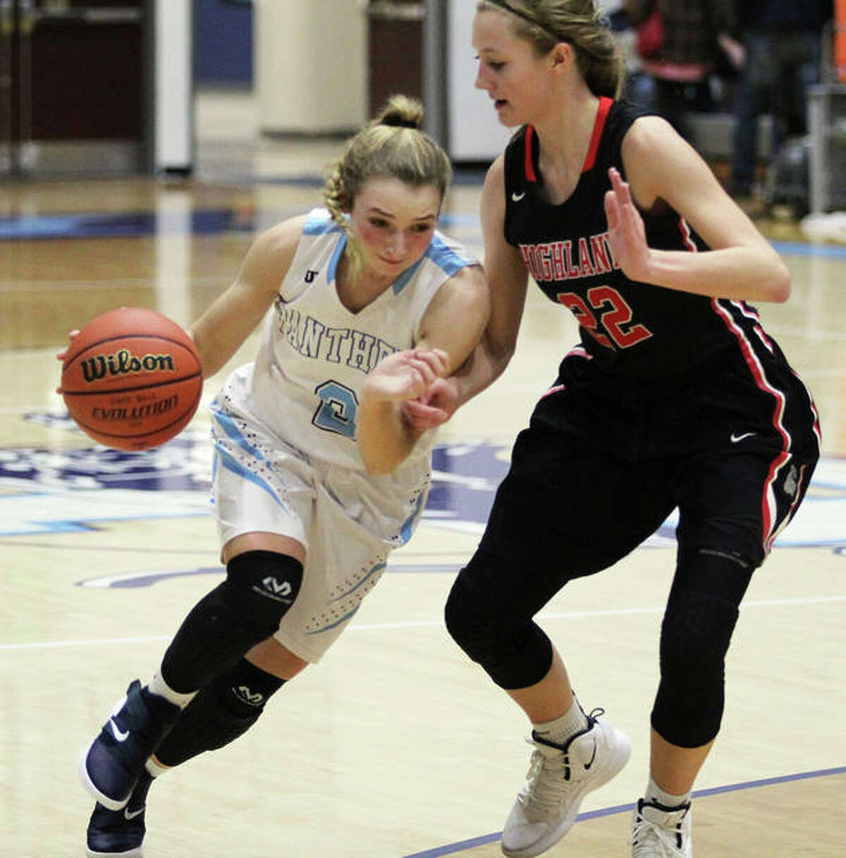 Jersey’s Brooke Tuttle (left), shown driving on Highland’s Ashlyn Klucker in a game Dec. 3 in Jerseyville, scored eight points Thursday night in the Panthers’ MVC victory at Triad.