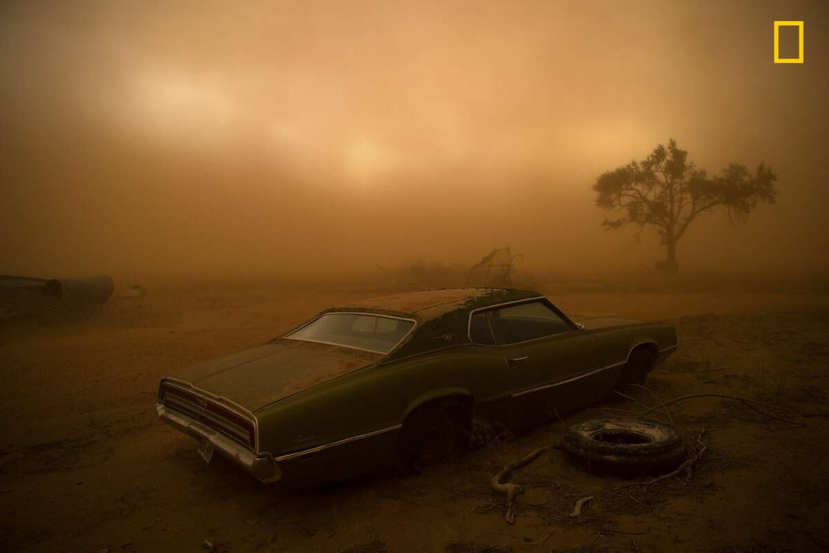 Winners of the 2018 National Geographic Photo Contest, 2nd Place, Places A rusting Ford Thunderbird is blanketed by red dust from a supercell thunderstorm in Ralls, Texas. The dry, plowed fields of the Texas Panhandle made easy prey for the storm, which had winds over 90 miles an hour ripping up the topsoil and depositing it farther south. I was forecasting and positioning a team of videographers and photographers on a storm chase in Tornado Alley—this was our last day of a very successful chase, having witnessed 16tornadoes over 10 days. The target area for a storm initiation was just south of Amarillo, Texas. Once the storm became a supercell, it moved southbound with outflow winds that were easily strong enough to tear up the topsoil and send it into the air. Link: https://yourshot.nationalgeographic.com/photos/12878491