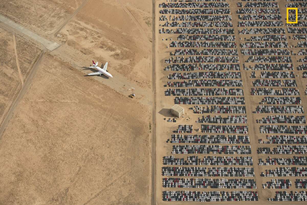 Winners of the 2018 National Geographic Photo Contest, Grand Prize Winner Thousands of Volkswagen and Audi cars sit idle in the middle of California's Mojave Desert. Models manufactured from 2009 to 2015 were designed to cheat emissions tests mandated by the U.S. Environmental Protection Agency. Following the scandal, Volkswagen recalled millions of cars. By capturing scenes like this one, I hope we will all become more conscious of and more caring toward our beautiful planet. Link: https://yourshot.nationalgeographic.com/photos/12295249