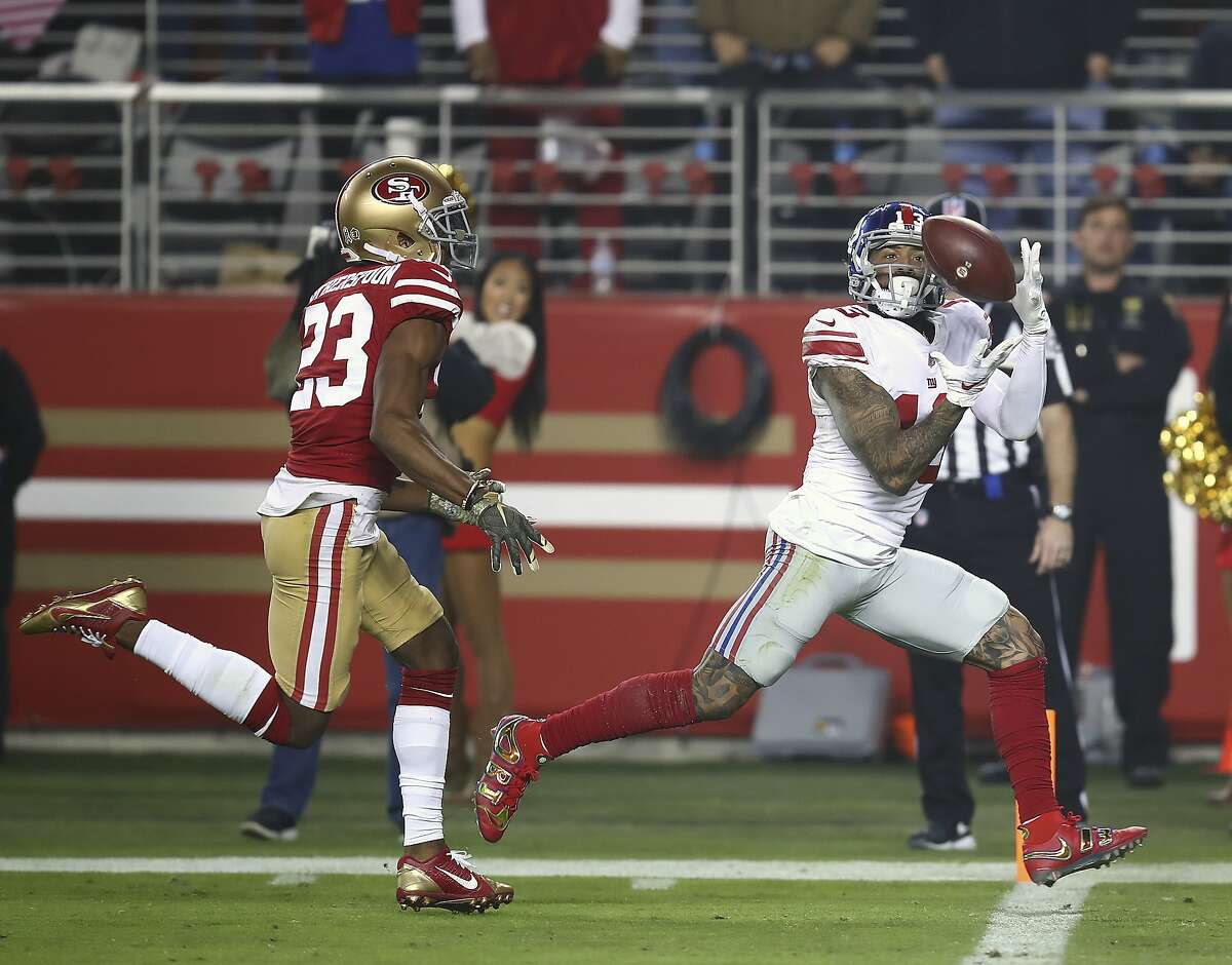 FILE - In this Nov. 12, 2018, file photo, New York Giants wide receiver Odell Beckham Jr., right, catches a touchdown pass in front of San Francisco 49ers cornerback Ahkello Witherspoon (23) during the second half of an NFL football game in Santa Clara, Calif. Odell Beckham Jr. will miss his second straight game with a quad injury. Coach Pat Shurmur said Friday, Dec. 14, 2018, the NFL's highest-paid receiver won't play Sunday against the Tennessee Titans at MetLife Stadium. (AP Photo/Ben Margot, File)