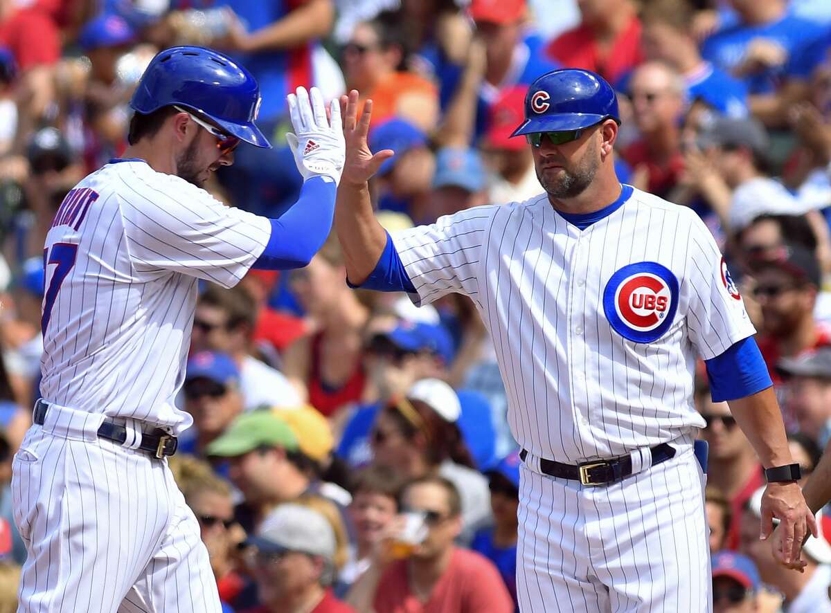 CHICAGO, IL - JULY 22: Chicago Cubs third baseman Kris Bryant (17) celebrates with Chicago Cubs first base coach Brandon Hyde (16) after hitting the ball for a single during the game between the St. Louis Cardinals and the Chicago Cubs on July 22, 2017 at Wrigley Field in Chicago, Illinois. (Photo by Quinn Harris/Icon Sportswire via Getty Images)