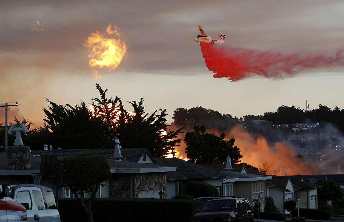 FILE - In this Sept. 9, 2010, file photo, a massive fire following a pipeline explosion roars through a mostly residential neighborhood in San Bruno, Calif. The California Public Utilities Commission said Friday, Dec. 14, 2018, that an investigation by its staff found Pacific Gas & Electric Co. lacked enough employees to fulfill requests to find and mark natural gas pipelines. A U.S. judge fined the utility $3 million after it was convicted of six felony charges for failing to properly maintain a natural gas pipeline that exploded south of San Francisco in 2010, killing eight people. (AP Photo/Jeff Chiu, File)