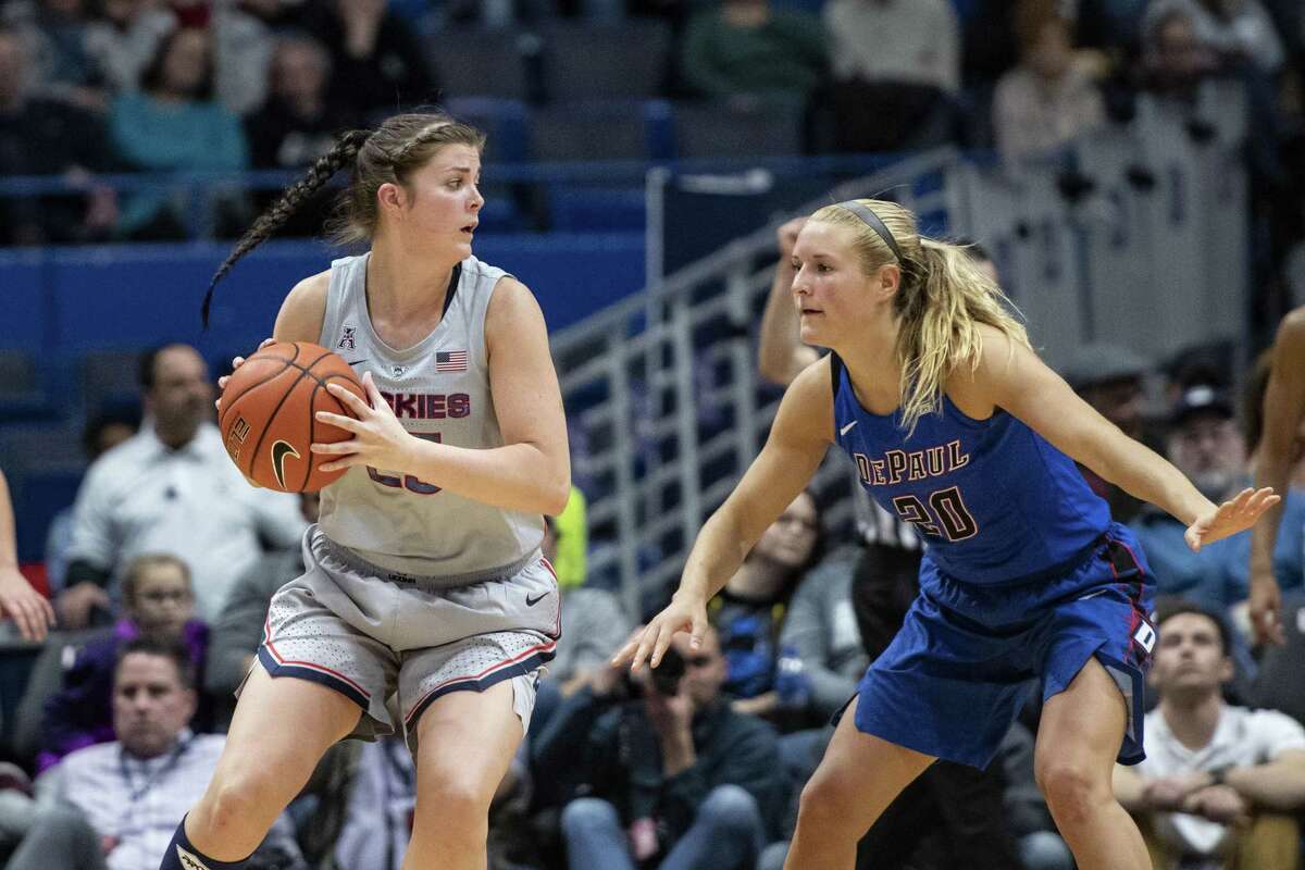 STORRS, CT - NOVEMBER 28: Connecticut Huskies Forward Kyla Irwin (25) looks to pass the ball with DePaul Blue Demons Guard Kelly Campbell (20) defending during the second half of the DePaul Blue Demons versus the Connecticut Huskies on November 28, 2018, at the XL Center in Hartford, CT. (Photo by Gregory Fisher/Icon Sportswire via Getty Images)