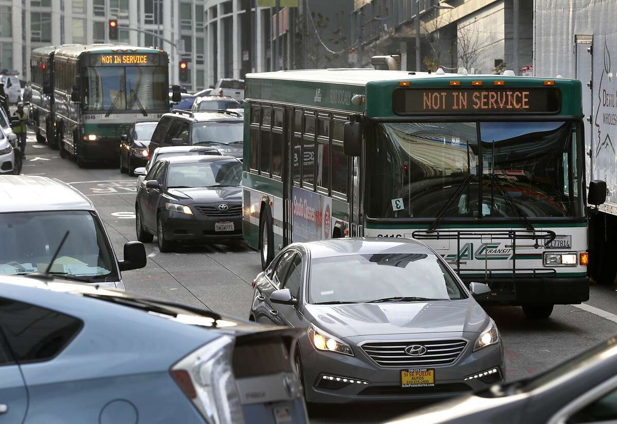 AC Transit buses on Fremont Street make their way through the morning commute to the Temporary Transbay Terminal in San Francisco, Calif. on Wednesday, Dec. 12, 2018. With the extended closure of the new Salesforce Transit Center, buses exiting the Bay Bridge have been forced to navigate clogged city streets adding several minutes to commute times and frustrating passengers.
