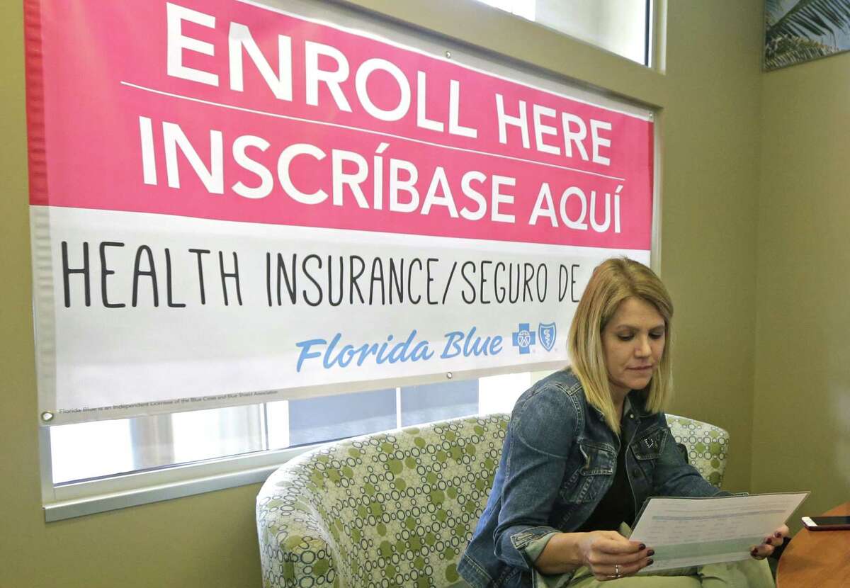 Catherine Reviati reviews the different Affordable Care Act enrollment options, Thursday, Nov. 2, 2017, in Hialeah, Fla. Health care advocacy groups are making an against-all-odds effort to sign people up despite confusion and hostility fostered by Republicans opposed to former President Barack Obama's signature domestic policy achievement. (AP Photo/Alan Diaz)
