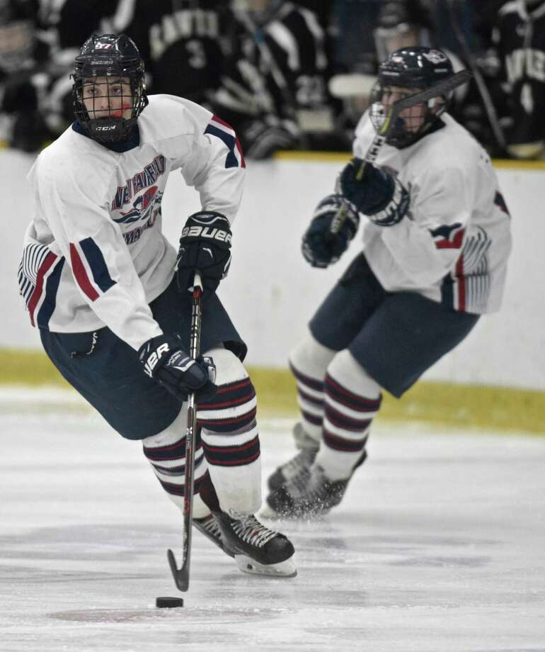 nfis sam mitchell (97) moves the puck in the boys high school