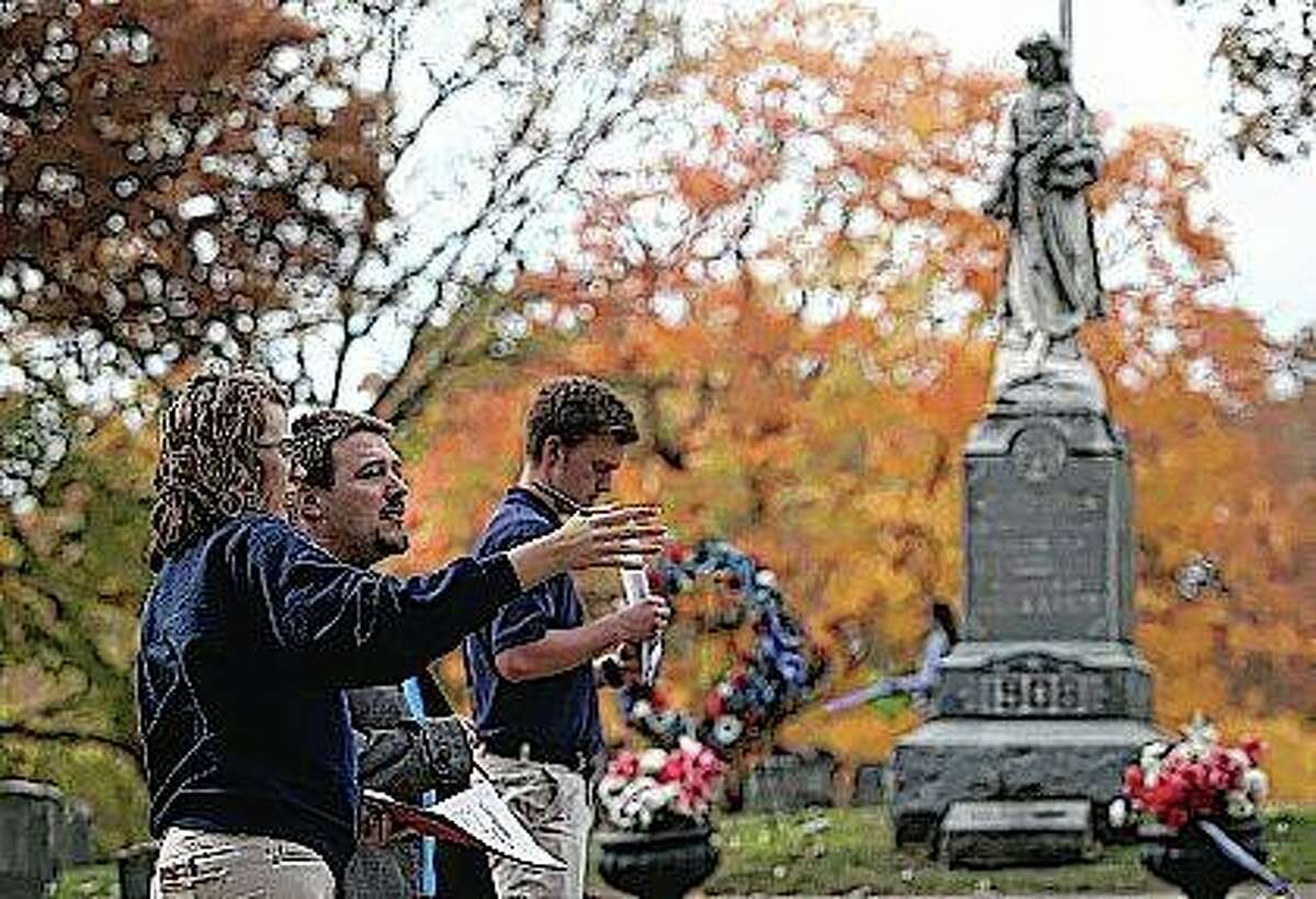 St. Teresa High School student Taylor Prasun (from left) talks to teacher Mario Podeschi and student Mitchell Vandercar about a strategy for recording gravestone information for a sociology class project at Greenwood Cemetery in Decatur for a sociology class project. Greenwood is an old cemetery, probably the oldest in Decatur. The students chose the Civil War section of Greenwood Cemetery to research because they wanted the oldest graves possible.