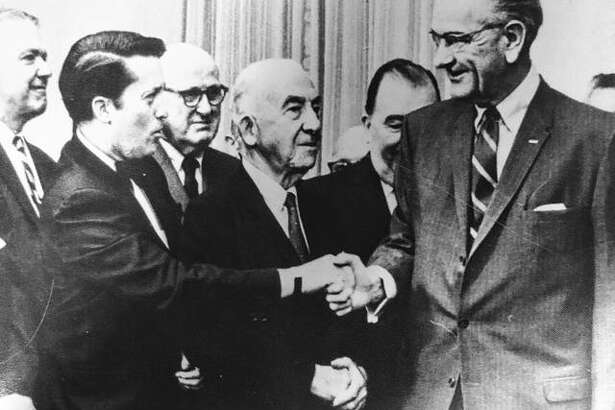 Kenneth J. Gray, “the Prince of Pork,” shakes hands with Lyndon B. Johnson, known for his wheeling and dealing in the U.S. Senate.