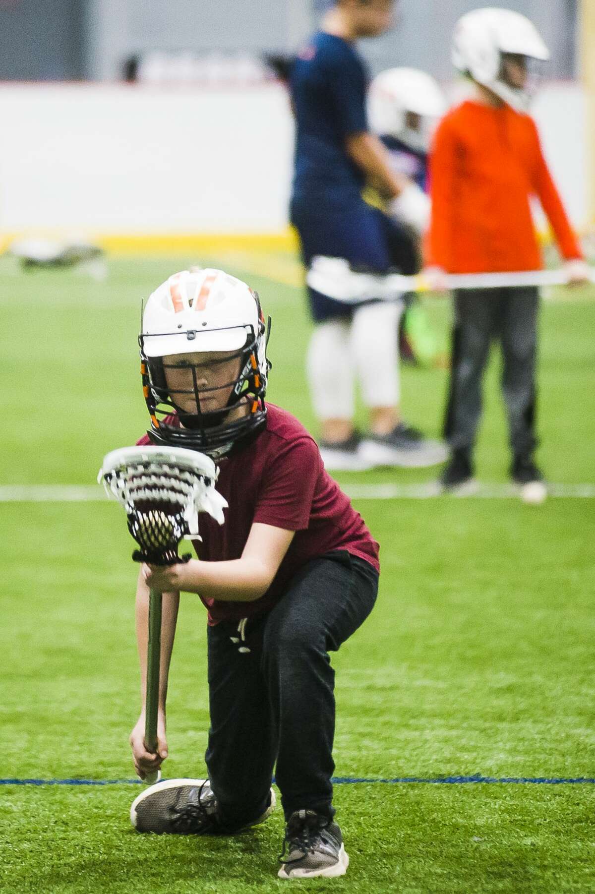 Trevor Shuart of Freeland, 9, practices scooping the ball during a "Try Lacrosse Free" event hosted by the Midland Lacrosse Club on Saturday, Dec. 15, 2018 at Midland Civic Arena. (Katy Kildee/kkildee@mdn.net)