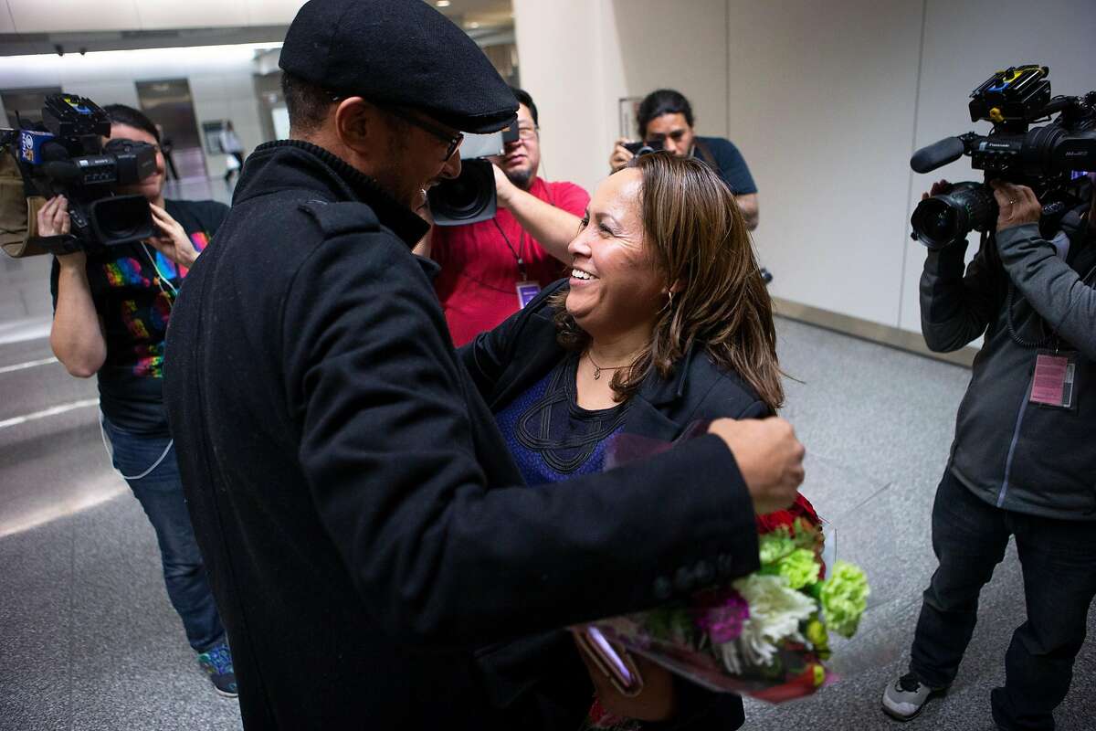 Maria Mendoza-Sanchez (right) hugs her Highland Hospital co-worker Harinet Shale at SFO on Saturday, Dec. 15, 2018, in San Francisco, Calif. Mendoza-Sanchez, a nurse who was separated from her children and deported to Mexico last year after more than two decades in Oakland, won her improbable fight to return to the United States. Her visa was approved by U.S. Citizenship and Immigration Services.