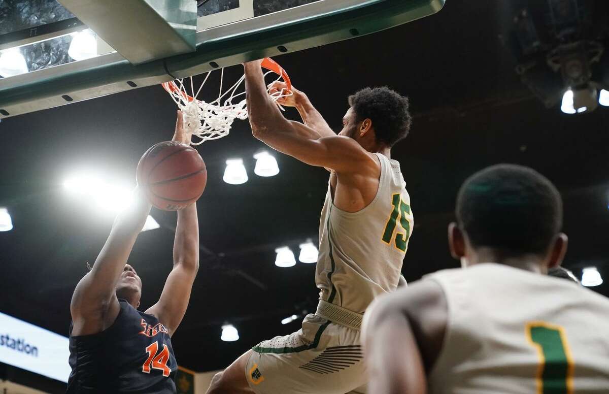 University of San Francisco's Nate Renfro dunks the ball against Cal State Fullerton defense at the War Memorial Gymnasium in San Francisco, Calif. on Sunday, Dec 16, 2018.