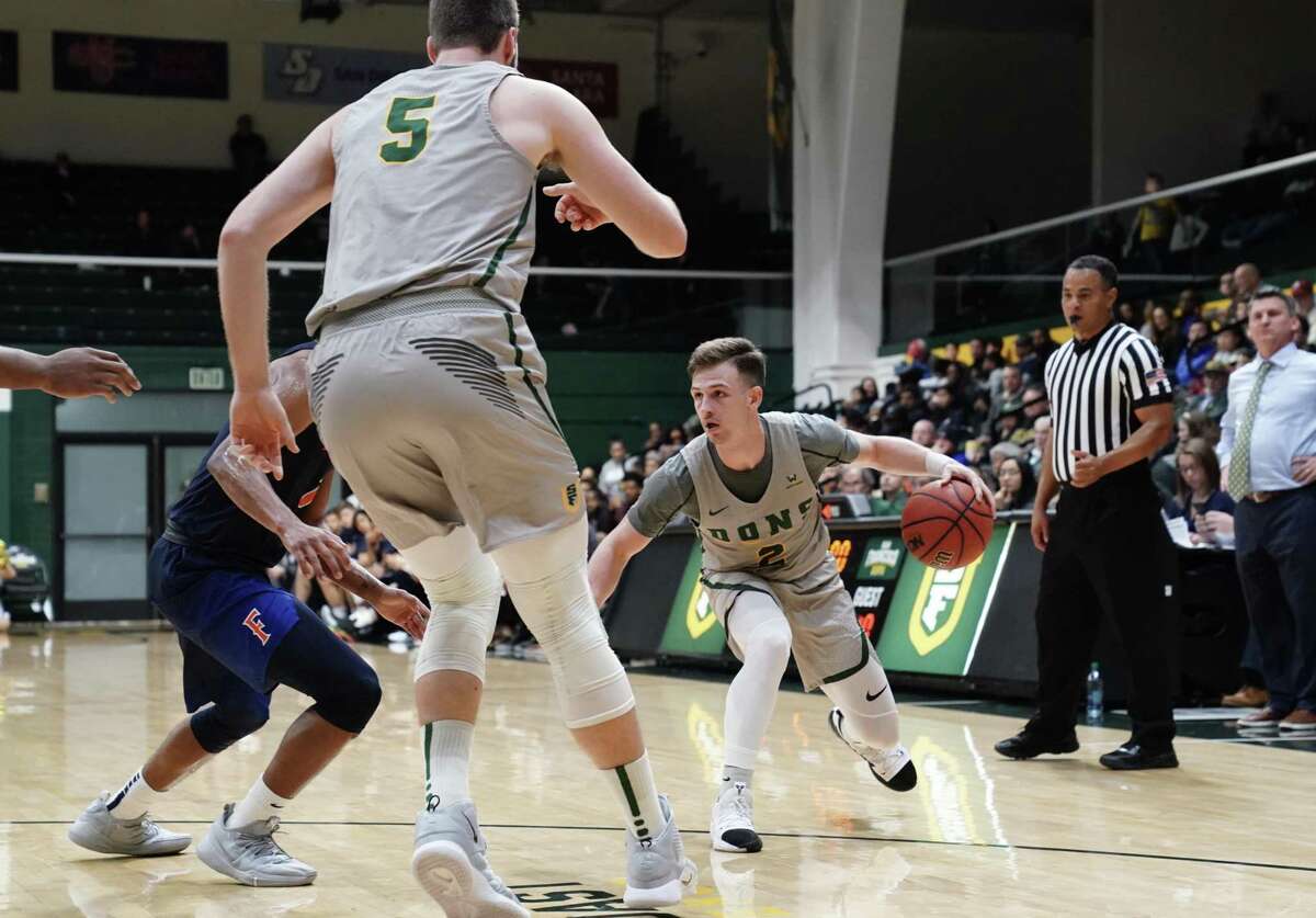 Frankie Ferrari of the University of San Francisco dribbles the ball against Cal State Fullerton defense at the War Memorial Gymnasium in San Francisco, Calif. on Sunday, Dec 16, 2018.