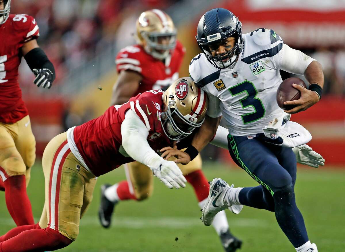 San Francisco 49ers' DeForest Buckner tackles Seattle Seahawks' Russell Wilson in 4th quarter during Niners' 26-23 win in overtime in NFL game at Levi's Stadium in Santa Clara, Calif. on Sunday, December 16, 2018.