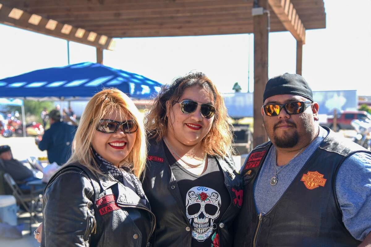 Mayra Alaniz, Mary Galvan and Pepe Rosales pose for a photo during the Harley Davidson Christmas Party and Menudo Cook-Off.