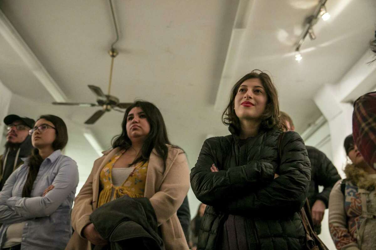 Audience members listen to Kimiya Factory, 20, as she shares her poem ‘Hold My Hand’ during the VOZ exhibit at The Movement Gallery that featured work of survivors of sexual violence on Dec. 8, 2018. Factory, as well as Taylor Waits and other students, have been working to voice their dissatisfaction with UTSA’s handling of sexual assault investigations. They say they want to change the ‘rape culture’ on campus.