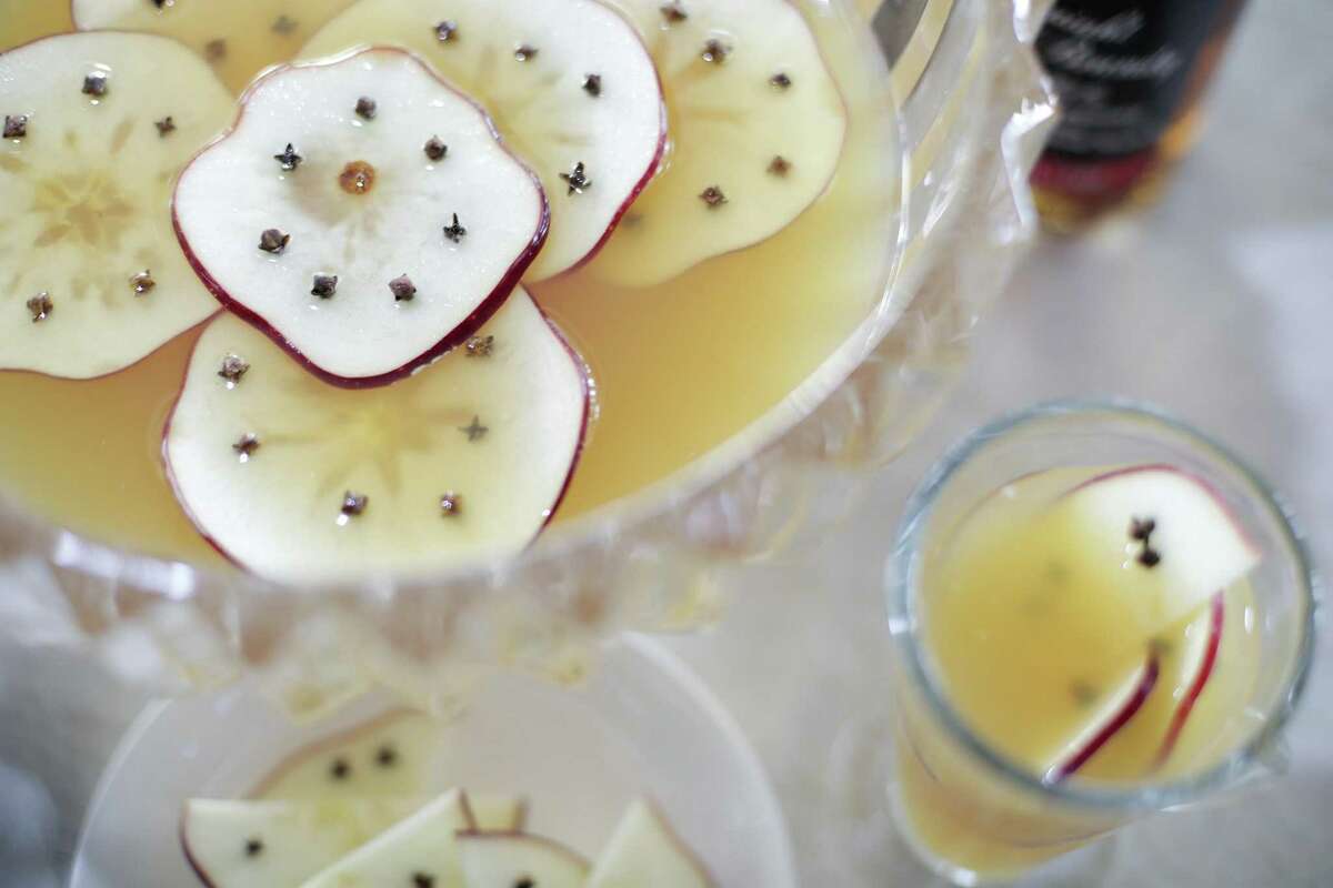 Apples studded with cloves decorate Apple Spice Island Tea, a punch bowl cocktail from Third Coast beverage director David Cook.