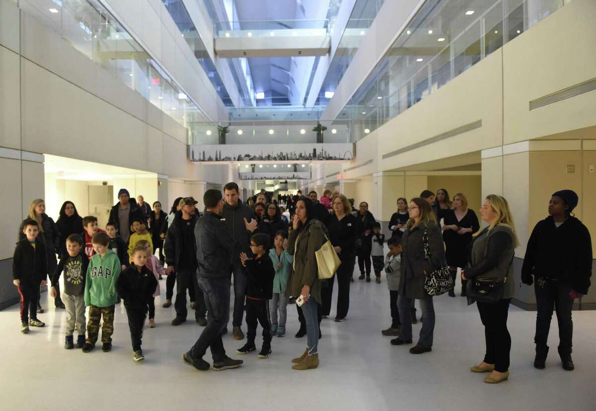 Parents and students attend an open house for the new Westover Magnet Elementary School, dubbed Westover @ 1 Elmcroft, in the Harbor Point neighborhood of Stamford, Conn. Tuesday, Nov. 13, 2018. Students were required to relocate after a severe mold problem was found in the school, so kids will now attend school in an office building with certain floors repurposed to suit students' learning needs.