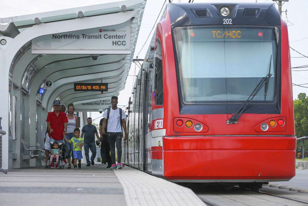 Riders disembark a Metro Red Line light rail train at the HCC Northline Commons station on Fulton Street near E. Crosstimbers Street in Houston on July 30, 2018.