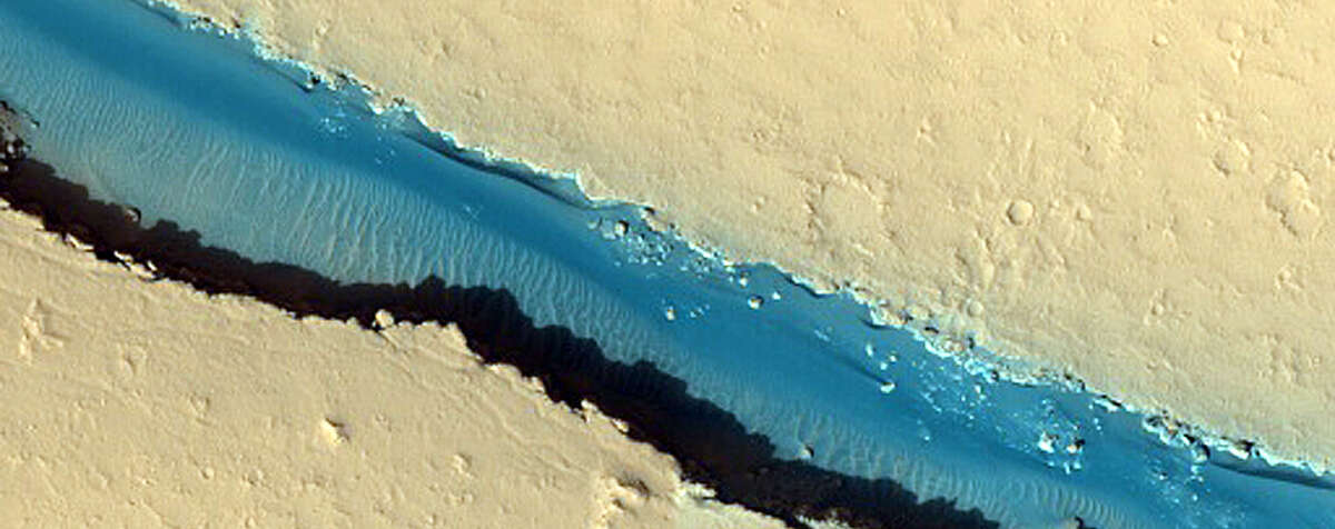 New photos published in December that were taken onboard the Mars Reconnaissance Orbiter with the High-Resolution Imaging Science Experiment show how eerily Earth-like yet pleasantly alien Mars exactly is.