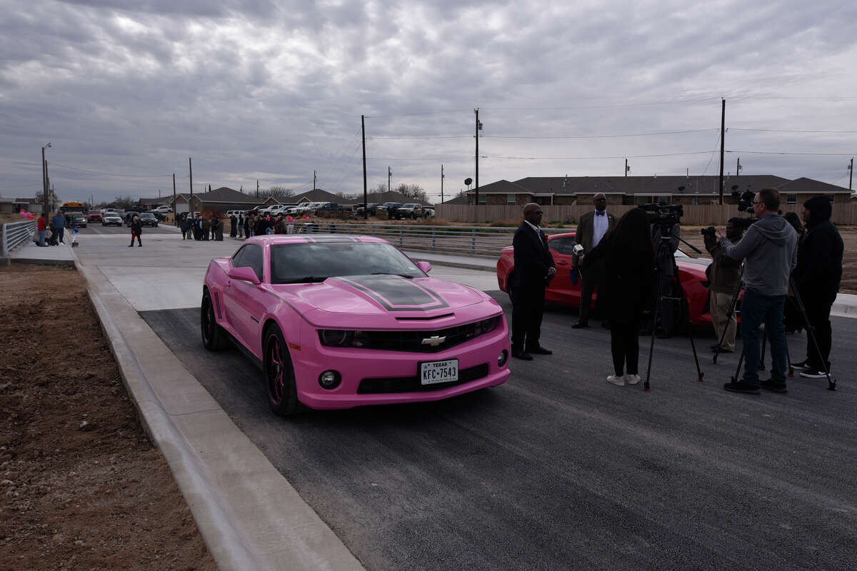 Larry Sims, owner of Classics Auto Paint & Body, is interviewed by the media with a car he built as a tribute to his late wife Terry, during the grand opening and dedication event for the newly constructed Carver Street bridge over the Scharbauer Draw, Dec. 18, 2018. The bridge is being named for the Terry Simms, who once helped rescue stranded motorists out of the Carver Street low-water crossing that would frequently flood during rainstorms. Construction of the bridge was funded by the Midland Development Corporation. James Durbin / Reporter-Telegram