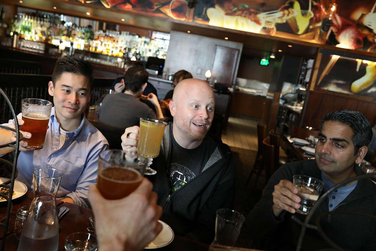 Mark Williamson (center), MasterClass chief operating officer, gives a toast to staff at a MasterClass holiday office party with Charles Taira (left), Jeevan Balani (right) and others at Zero Zero on Tuesday, December 18, 2018 in San Francisco, Calif.