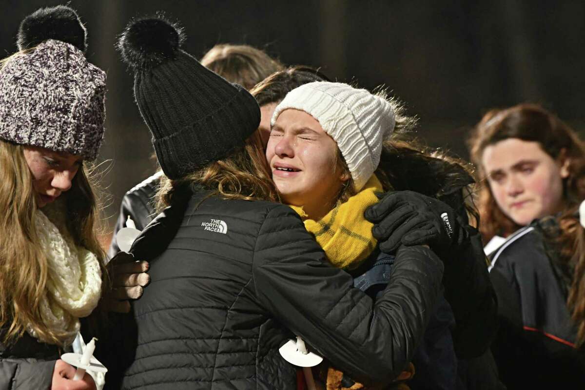 Classmates get emotional while singing "Silent Night" as they attend a vigil to honor seventh-grader Emma Jones at the Ballston Spa High School football field on Tuesday, Dec. 18, 2018 in Ballston Spa, N.Y. Jones was killed as part of what police say was a murder-suicide. (Lori Van Buren/Times Union)