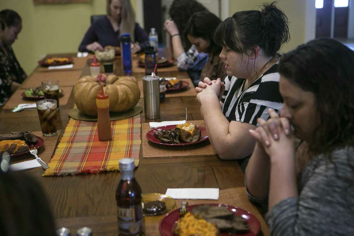 Kirstie Elrod gives the blessing for lunch at Grace House of San Antonio, Friday, Nov. 9, 2018. Elrod came to Grace House after getting out of jail and knew that she "needed to do something when I got out" and Grace House has been a good fit for her.