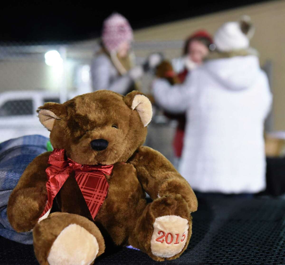 Buddy Blankets & Bears charity hands out blankets and Emma bears to people as they arrive to attend a vigil to honor seventh-grader Emma Jones at the Ballston Spa High School football field on Tuesday, Dec. 18, 2018 in Ballston Spa, N.Y. Jones was killed as part of what police say was a murder-suicide. (Lori Van Buren/Times Union)
