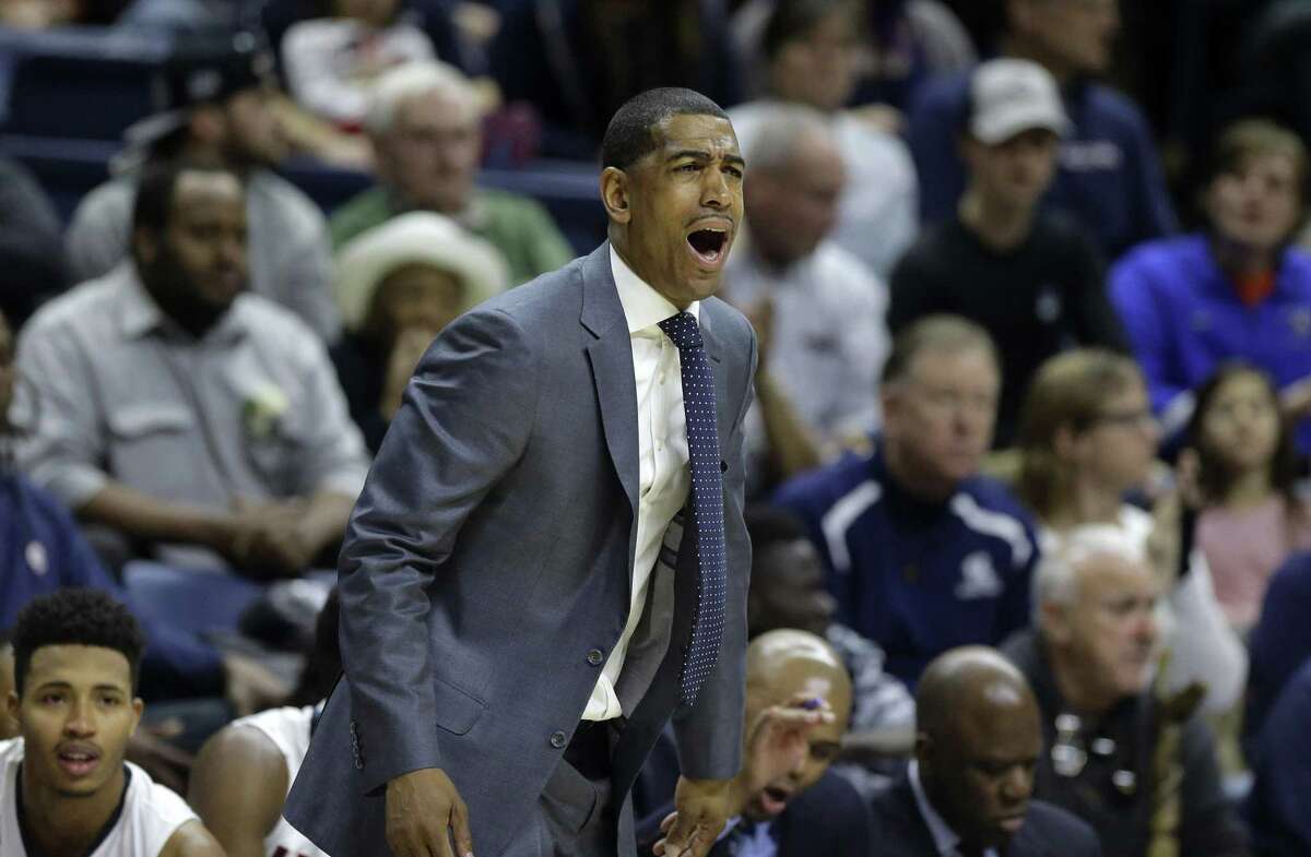 UConn coach Kevin Ollie calls to his team from the bench during March 2016 game.