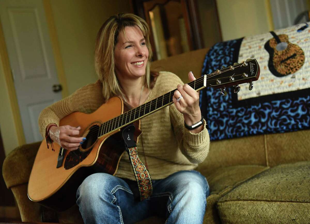 Kim Wickham plays her guitar at her home on Friday, Dec. 14, 2018 in Glenmont, N.Y. Wickham was a Syracuse University student studying in London in fall 1988 and had a flight home on Pan Am flight 103 on Dec. 21 but decided to stay abroad for the holidays. Many of her friends died when the flight was destroyed by a bomb over Lockerbie, Scotland. (Lori Van Buren/Times Union)