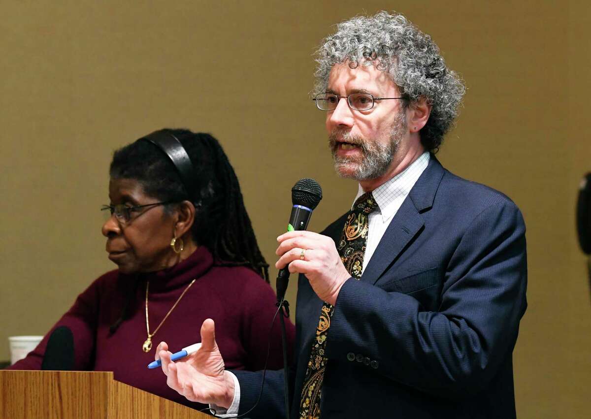 Dr. Alice Green Executive Director of the Center for Law and Justice, left and Attorney Mark Mishler, speak with community activists at a community forum at the Howe Branch library in Albany, N.Y. in  December 2018.