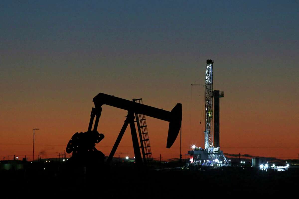 An oil rig and pump jack in Midland, Texas. The fossil fuels industry lost an estimated 118,000 jobs between March and July as the coronavirus pandemic plunged demand for petroleum products and electricity, according to BW Research Partnership.