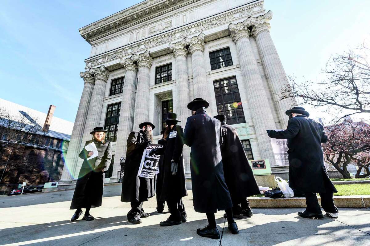 A group of Satmar Orthodox Jews demonstrate their feelings about potential changes to the Education Law in front of the State Education Building Thursday Dec. 20, 2018 in Albany, N.Y. (Skip Dickstein/Times Union)