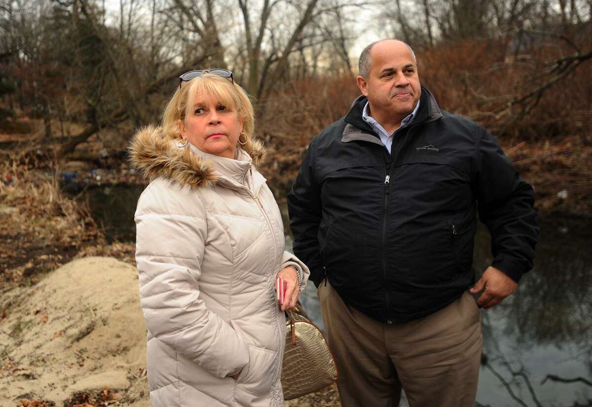 Susan Zaleta, of Fairfield, and Fairfield Public Works Director Joe Michelangelo survey the Rooster River where debris is being removed to aid water flow in Mountain Grove Cemetary in Bridgeport, Conn. on Thursday, December 20, 2018. Zaleta's Lewis Drive home was flooded by the river during torrential rains on September 25.